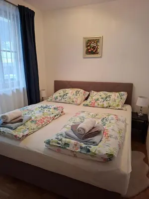 a bedroom with two beds with pillows and a window at Mountain spring in Kranjska Gora