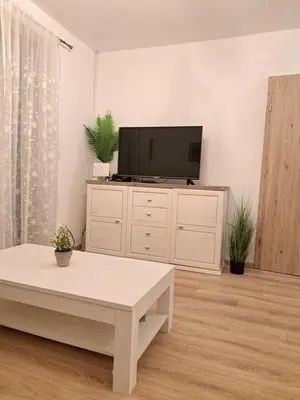 a living room with a tv and a coffee table at Mountain spring in Kranjska Gora