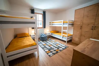 a room with two bunk beds and a desk at Apartment Bolfenk Pohorje - Forest nest in Pohorje