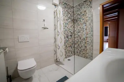 a bathroom with a shower and a toilet and a sink at Apartment Bolfenk Pohorje - Forest nest in Pohorje