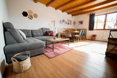 a living room with a couch and a table at Apartment Bolfenk Pohorje - Forest nest in Pohorje