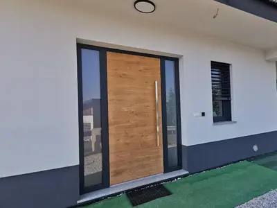 a wooden door on the side of a house at Apartma Gaber in Veliki Gaber