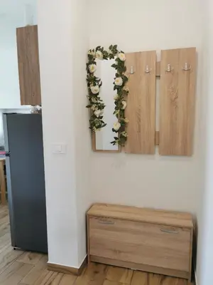 a room with a wall with a flower garland at Apartma Gaber in Veliki Gaber