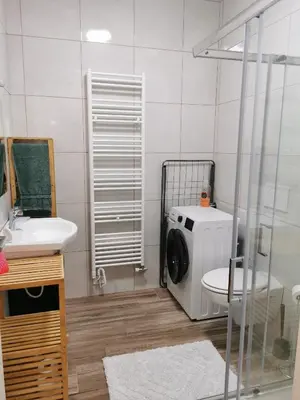 a bathroom with a washing machine and a sink at Apartma Gaber in Veliki Gaber