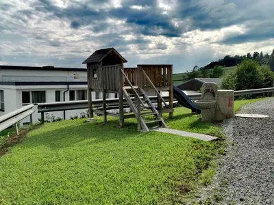 a park with a playground with a slide at Apartma Gaber in Veliki Gaber