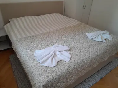 a bed with two white towels on it at Apartma Dea in Nova Gorica