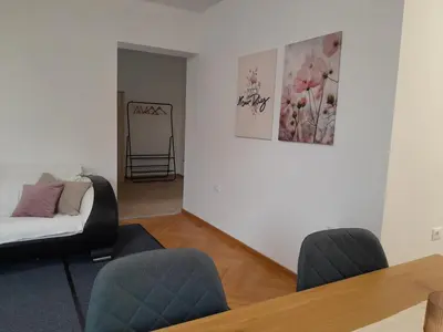 a living room with a couch and a table and chairs at Apartma Dea in Nova Gorica