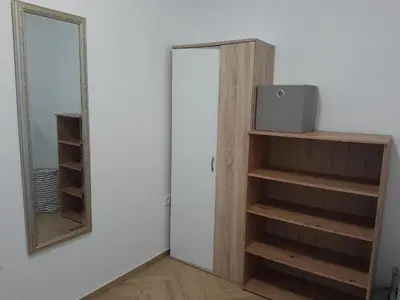 a room with a mirror and a book shelf at Apartma Dea in Nova Gorica
