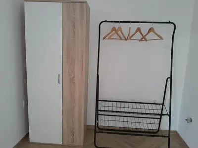 a black rack with hangers in a room at Apartma Dea in Nova Gorica