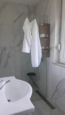 a bathroom with a sink and a toilet and towels at Apartma Dea in Nova Gorica