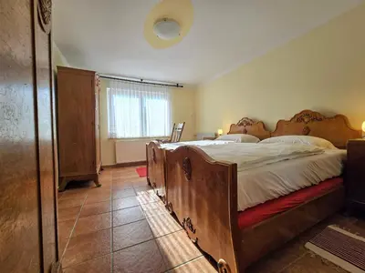 a bedroom with a large wooden bed in a room at At Granny's in Maribor