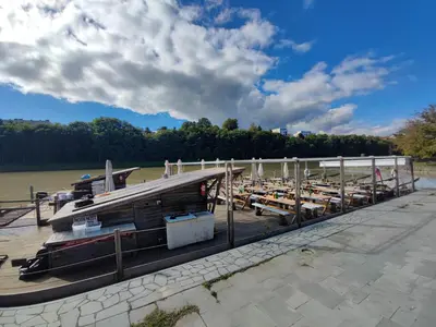 a boat is docked at a dock on a river at At Granny's in Maribor