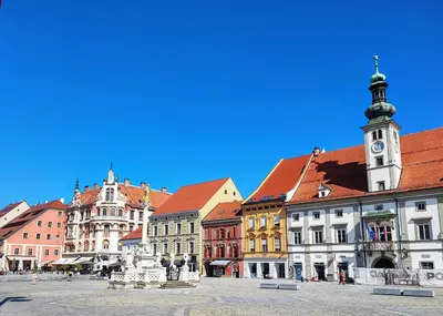 a city square with a clock tower and buildings at At Granny's in Maribor