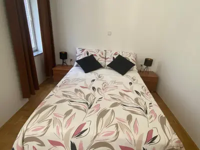 a bed with two pillows on it in a bedroom at Apartma ROGATEC 2 in Rogatec