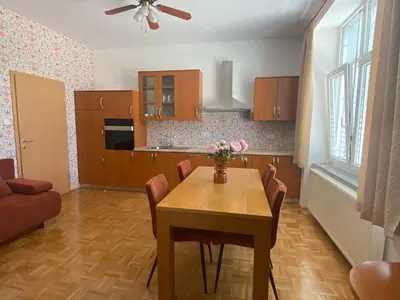 a kitchen and dining room with a table and chairs at Apartma ROGATEC 2 in Rogatec