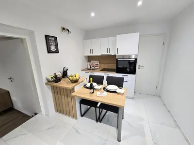 a kitchen with a wooden table in a room at GOLDEN OASIS Free Private Parking in Ljubljana