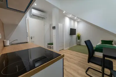 a kitchen and a living room with a bed at GOLDEN OASIS Free Private Parking in Ljubljana