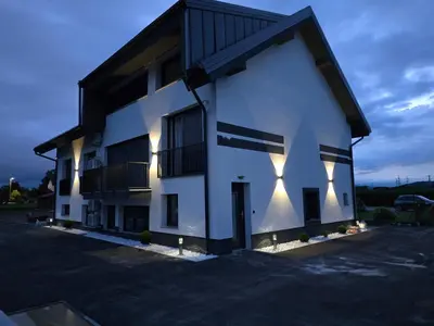 a white building with lights on the side of it at GOLDEN OASIS Free Private Parking in Ljubljana