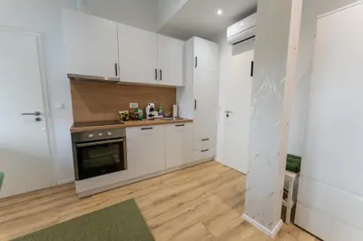 a kitchen with white cabinets and a stove at GOLDEN OASIS Free Private Parking in Ljubljana