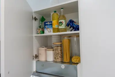 a kitchen pantry with food items on shelves at GOLDEN OASIS Free Private Parking in Ljubljana