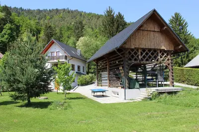 a house with a wooden pavilion in a yard at Vila Katarina in Hrastenica