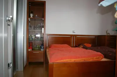 a bedroom with a bed with a red comforter at Vila Katarina in Hrastenica