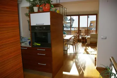 a kitchen with a large wooden cabinet with a tv in it at Vila Katarina in Hrastenica