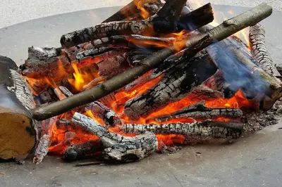 a fire with some sticks on top of it at Vila Katarina in Hrastenica