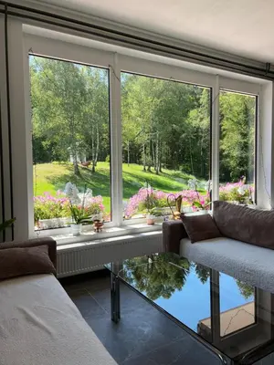 a living room with a large window with a view at Gaj pod brezami in Luče