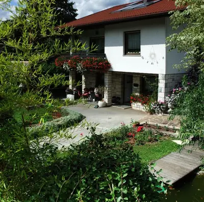 a house with flowers in front of it at Apartment MaLa in Bled