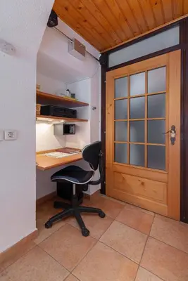 an office with a desk and a chair and a door at Apartment MaLa in Bled