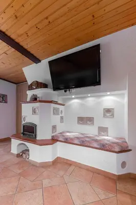 a living room with a flat screen tv on a wall at Apartment MaLa in Bled