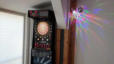 a dart board with a wheel on a wall at Apartments Akacijev Izvir in Miklavž na Dravskem Polju