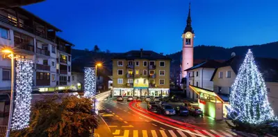 a town with christmas trees and a clock tower at Apartments Shock in Cerkno