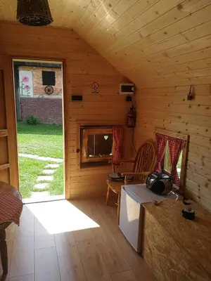 a room with a wooden cabin with a table and a window at Farm Stay Pr Lavric in Slivna