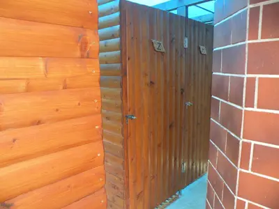 a wooden wall with a wooden door on a brick wall at Farm Stay Pr Lavric in Slivna