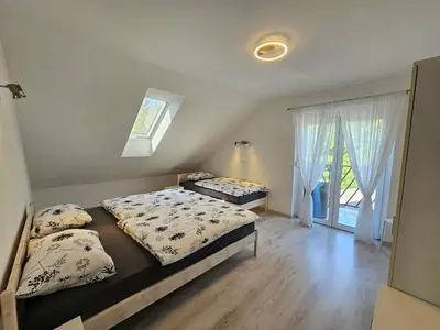a bedroom with two beds and a window at Green Hill Apartments in Žirovnica