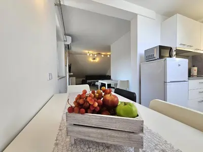 a bowl of fruit on a table in a kitchen at Green Hill Apartments in Žirovnica