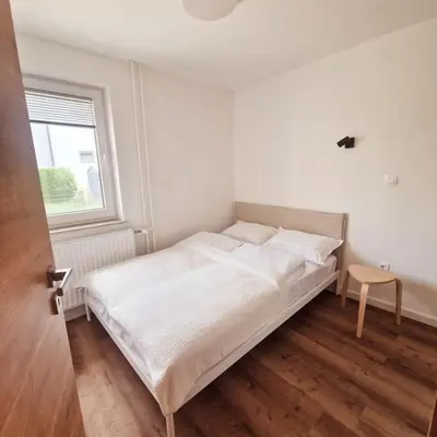 a white bed in a room with a window at Apartment Little Heaven in Zbilje