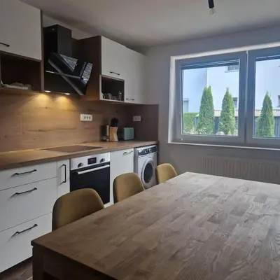 a kitchen with a large wooden table and a kitchen with a tableablish at Apartment Little Heaven in Zbilje