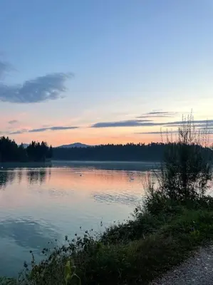 a large body of water with a sunset in the background at Apartment Little Heaven in Zbilje