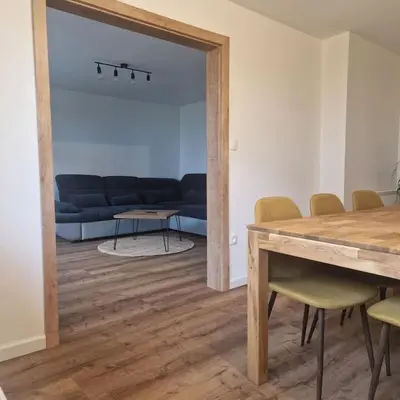 a living room with a blue couch and a table at Apartment Little Heaven in Zbilje