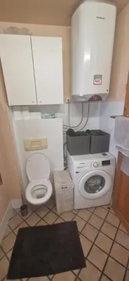 a bathroom with a toilet and a washing machine at Magic Garden in the heart of Ljubljana in Ljubljana