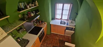 a kitchen with green walls and a white stove top oven at Magic Garden in the heart of Ljubljana in Ljubljana