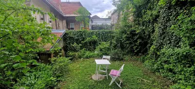 two chairs and a table in a garden at Magic Garden in the heart of Ljubljana in Ljubljana