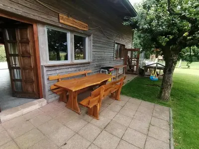 a wooden table and benches outside of a house at Hemp farm paradise near Bled and Ljubljana in Kranj