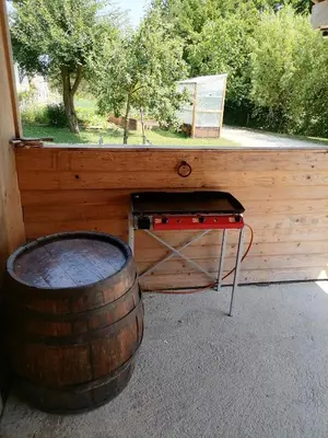 a table and a barrel next to a window at Hemp farm paradise near Bled and Ljubljana in Kranj