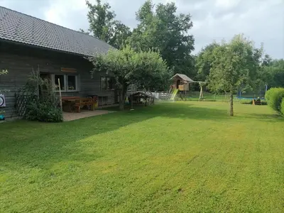 a log cabin with a yard and a playground at Hemp farm paradise near Bled and Ljubljana in Kranj