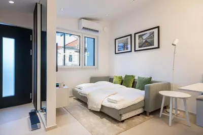 a bedroom with a bed and a table in it at Trubarjeva City apartments in Ljubljana