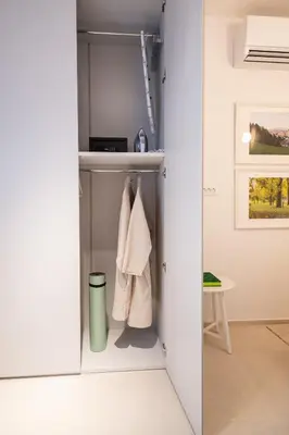 a walk in closet with white walls at Trubarjeva City apartments in Ljubljana